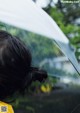 A woman holding an umbrella in the rain. 